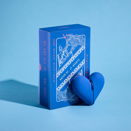 Blue heart shaped vibrator with packaging on a blue background