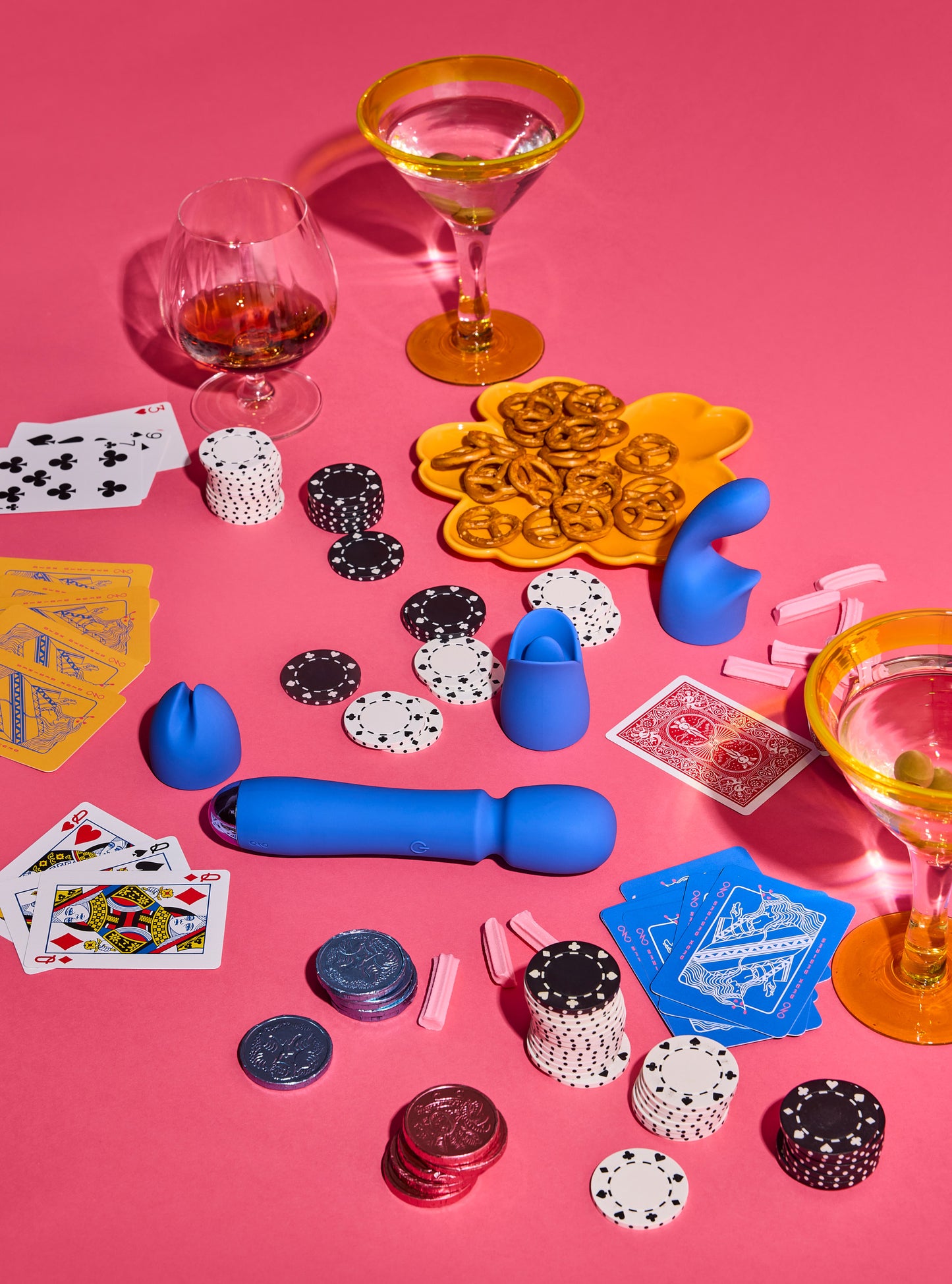 Poker-themed items including cards, chips, and dice on a pink background