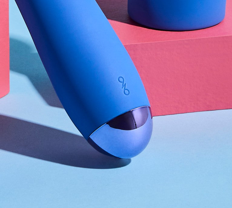 Blue silicone vibrator with a brand logo on a pink box