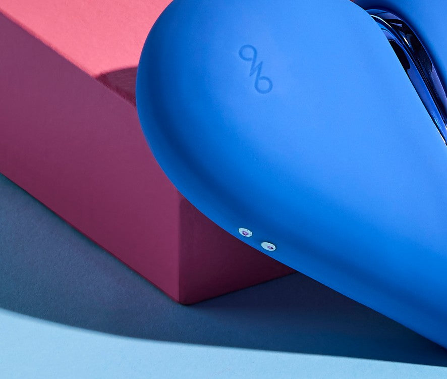 Blue silicone vibrator device with a brand logo on a pink box